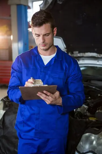 A skilled mechanic performing a thorough car inspection, ensuring safety and reliability for CarRepairGuru.com users