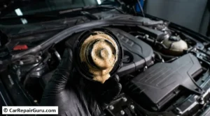 Close-up of a thick, creamy milkshake-like sludge under a car's oil filler cap, a classic blown engine symptom indicating coolant and motor oil have mixed due to a failed head gasket.